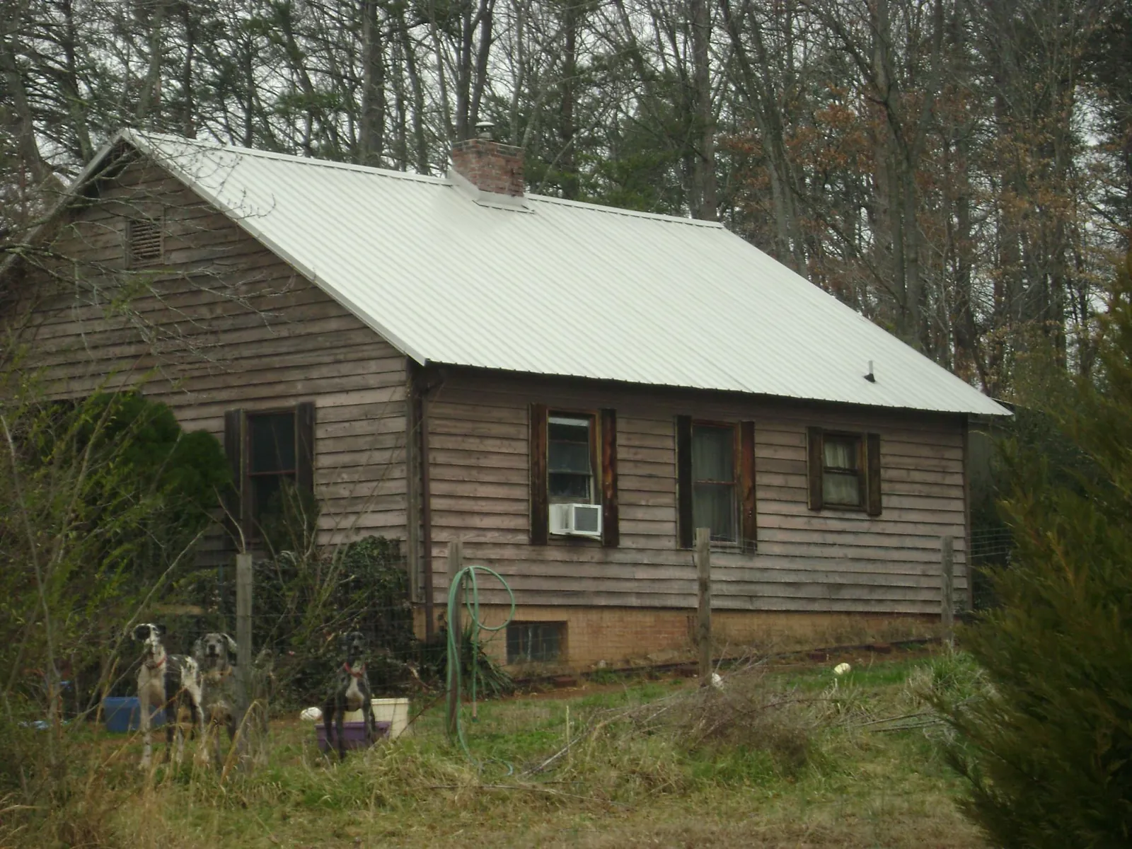 White metal roof on an old wood sided farmhouse, from a Metal Roof Installation job in Black River